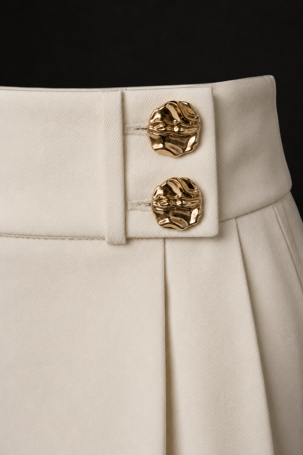 Close-up of the gold button waistband on AVENUE NOIR Signature Trousers